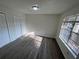 Bright bedroom featuring new flooring and a large window offering natural light and view at 4200 Thornbriar Ln # 208, Orlando, FL 32822