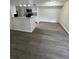 Modern kitchen featuring white cabinets, granite countertops, and stainless steel appliances open to living space at 4200 Thornbriar Ln # 208, Orlando, FL 32822