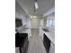 Bright and airy kitchen with modern appliances, granite countertops, and stylish finishes open to the living area at 4200 Thornbriar Ln # 208, Orlando, FL 32822