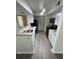 Long galley kitchen featuring stainless steel appliances, granite countertops, and modern fixtures at 4200 Thornbriar Ln # 208, Orlando, FL 32822