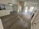 Bright living room with vaulted ceilings, fireplace, with wood-look floors, and access to kitchen area at 4200 Thornbriar Ln # 208, Orlando, FL 32822