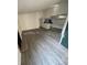 Spacious living room featuring modern flooring, fireplace, and open access to the adjacent kitchen at 4200 Thornbriar Ln # 208, Orlando, FL 32822