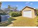 This property features a screened-in pool area, lush greenery, and a detached garage, creating a serene and private backyard at 4815 Doc Dr, St Cloud, FL 34771