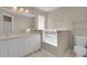 Bright bathroom boasts dual sinks, soaking tub, and neutral tones, offering a spa-like ambiance at 4815 Doc Dr, St Cloud, FL 34771