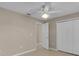 Neutral bedroom features tiled floor, a ceiling fan, and a closet with bi-fold doors at 4815 Doc Dr, St Cloud, FL 34771