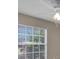View of a window, fan and some wall in a bedroom, with tan colored walls at 4815 Doc Dr, St Cloud, FL 34771