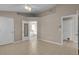 Large bedroom with neutral walls, tile flooring, and doors leading to the bathroom at 4815 Doc Dr, St Cloud, FL 34771