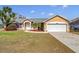 Charming single-story home featuring manicured lawn, well-kept landscaping, and an attached two-car garage at 4815 Doc Dr, St Cloud, FL 34771