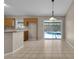 Spacious, sunlit kitchen, with tan tile floors, breakfast bar, and glass-paned doors to the pool at 4815 Doc Dr, St Cloud, FL 34771