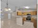 An open-concept kitchen with stainless steel appliances, tile flooring, and a breakfast bar at 4815 Doc Dr, St Cloud, FL 34771