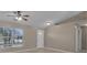 Inviting living room with vaulted ceiling, fan, and large window allowing for plenty of natural light at 4815 Doc Dr, St Cloud, FL 34771