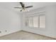 Bright bedroom features a ceiling fan and window with shutters at 5311 Burning Tree Dr # D, Orlando, FL 32811