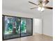 This bedroom features wood floors and a sliding door leading to backyard at 5311 Burning Tree Dr # D, Orlando, FL 32811