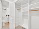 Walk-in closet with adjustable white shelving and access to toilet at 5311 Burning Tree Dr # D, Orlando, FL 32811