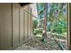 Exterior view from the ground featuring a private patio enclosed with privacy fencing and lush scenery at 5311 Burning Tree Dr # D, Orlando, FL 32811