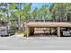 Exterior view of a condominium with covered parking and landscaping at 5311 Burning Tree Dr # D, Orlando, FL 32811