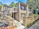 Inviting exterior of a two-story home with a wooden staircase leading to the upper level entrance at 5311 Burning Tree Dr # D, Orlando, FL 32811