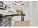 Bright kitchen boasts white cabinets, modern appliances, tile backsplash, and beverage cooler at 5311 Burning Tree Dr # D, Orlando, FL 32811