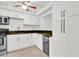 Bright kitchen features white cabinets, granite countertops, stainless steel appliances and wine cooler at 5311 Burning Tree Dr # D, Orlando, FL 32811
