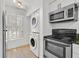 Stacked washer and dryer in laundry area next to stainless appliances at 5311 Burning Tree Dr # D, Orlando, FL 32811