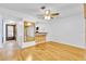 Bright living room with wood floors, mirror and kitchen view at 5311 Burning Tree Dr # D, Orlando, FL 32811