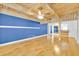 Bright living room with hardwood floors, blue accent wall and wood plank ceiling with fan at 5311 Burning Tree Dr # D, Orlando, FL 32811