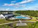 Aerial view showcases an inviting community pool area with ample seating and surrounding landscaping at 6808 Cranes Roost Rd, Harmony, FL 34773