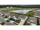 Aerial view of a residential neighborhood with a large pond, showcasing well-maintained homes at 6808 Cranes Roost Rd, Harmony, FL 34773