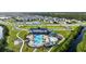 Extensive aerial view showcases community amenities, including a pool area and surrounding lush landscape at 6808 Cranes Roost Rd, Harmony, FL 34773