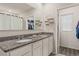 Granite counters, dual sinks, and bright light offer a luxurious feel in this modern bathroom at 6808 Cranes Roost Rd, Harmony, FL 34773
