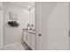 Bright bathroom featuring granite countertops, neutral walls, and a decorative towel rack at 6808 Cranes Roost Rd, Harmony, FL 34773