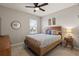Comfortable bedroom featuring a wooden bed frame, neutral bedding, and a ceiling fan at 6808 Cranes Roost Rd, Harmony, FL 34773