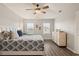 Bright primary bedroom with neutral walls, ceiling fan, and natural light from multiple windows at 6808 Cranes Roost Rd, Harmony, FL 34773