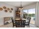 Cozy dining area featuring modern decor and sliding glass doors to the outdoor pool at 6808 Cranes Roost Rd, Harmony, FL 34773