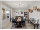 Dining room with modern chandelier, neutral color palette, and elegant furniture at 6808 Cranes Roost Rd, Harmony, FL 34773