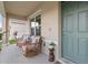 Inviting front porch with cozy seating area, providing a relaxing spot to enjoy the outdoors at 6808 Cranes Roost Rd, Harmony, FL 34773