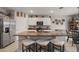 Bright kitchen featuring white cabinets, granite countertops, and a spacious island with seating at 6808 Cranes Roost Rd, Harmony, FL 34773