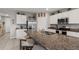 Bright kitchen featuring stainless steel appliances, white cabinets, and granite countertops at 6808 Cranes Roost Rd, Harmony, FL 34773