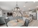 Open concept living area, with stairs, dining, and kitchen, featuring hardwood floors and modern design at 6808 Cranes Roost Rd, Harmony, FL 34773
