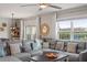 Comfortable living room with a large sectional sofa, decorative pillows, and modern decor at 6808 Cranes Roost Rd, Harmony, FL 34773