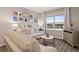 Cozy living room with white sofa and a view of the pond from the bright window at 6808 Cranes Roost Rd, Harmony, FL 34773
