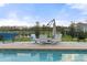 Outdoor lounge area by the pool with comfortable seating and scenic views of the surrounding landscape at 6808 Cranes Roost Rd, Harmony, FL 34773