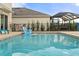 The refreshing pool includes an outdoor bar and grill, great for backyard fun at 6808 Cranes Roost Rd, Harmony, FL 34773