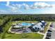 A lovely aerial view of the community pool and clubhouse showcasing the wonderful amenities at 6808 Cranes Roost Rd, Harmony, FL 34773