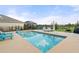 Backyard pool with relaxing patio seating, screened-in porch and view of the pond at 6808 Cranes Roost Rd, Harmony, FL 34773