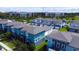 Aerial view of townhomes in a planned community featuring attached garages, green lawns, and consistent architectural design at 7381 Alpine Butterfly Ln, Orlando, FL 32819