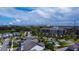 Expansive aerial view of a residential community with lush landscaping and modern buildings against a bright blue sky at 7381 Alpine Butterfly Ln, Orlando, FL 32819