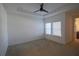 Spacious bedroom with a ceiling fan and two windows providing natural light at 7381 Alpine Butterfly Ln, Orlando, FL 32819