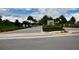 Wide angle of the Sand Lake Sound entrance with palm trees at 7381 Alpine Butterfly Ln, Orlando, FL 32819