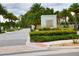 Sand Lake Sound entrance with palm trees and manicured landscaping at 7381 Alpine Butterfly Ln, Orlando, FL 32819